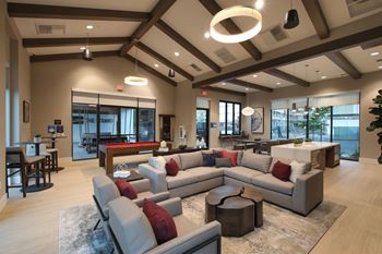 Clubroom with a large grey sofa and a coffee table.